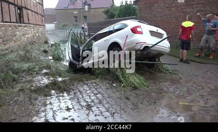 18 août 2020, Saxe-Anhalt, Oschersleben: Une voiture qui a été emportée par les masses d'eau est suspendue dans un lit de ruisseau après une tempête lourde de pluie et de grêle. Photo: Florian Voigt/TNN/dpa Banque D'Images