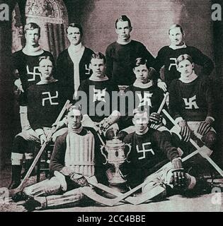 Photo rétro d'une équipe canadienne de hockey avec un signe de la croix gammée sur ses chandails. 1910s Banque D'Images