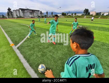 (200819) -- ZHAOJUE, 19 août 2020 (Xinhua) -- photo prise le 11 août 2020 montre des enfants de l'équipe de Zhaojue Real Madrid jouant au football sur le terrain de Lamo dans le comté de Zhaojue, dans la province du Sichuan, dans le sud-ouest de la Chine. Javier Moros Barrera, un entraîneur de 30 ans de l'UEFA A Level de la ville de Saragosse, Espagne Depuis le 13 juillet 2020, une équipe de football composée de 15 garçons du comté de Zhaojue et de villages ruraux près du comté de la province du Sichuan en Chine est formée. L'équipe de football appelée Zhaojue Real Madrid fait partie d'un projet de formation lancé en octobre dernier et soutenu par Real Madrid Foundati Banque D'Images