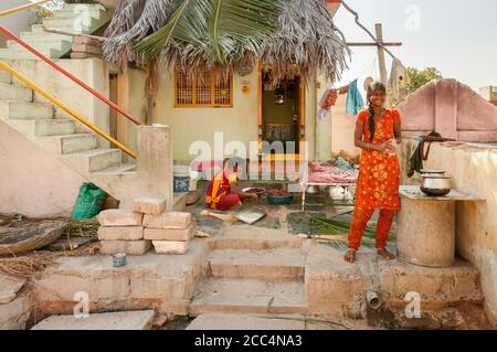 Puttaparthi, Andhra Pradesh, Inde - le 12 janvier 2013 : de jeunes indiennes font des travaux ménagers à l'extérieur du foyer de Puttaparthi, en Inde Banque D'Images