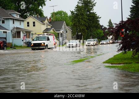 Les citoyens de fond du Lac traversent les rues inondées dans leurs véhicules de l'énorme déversage de pluie durant l'après-midi de juillet 2020. Banque D'Images