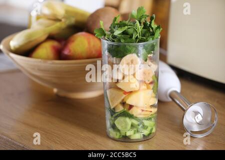 Verre de délicieux yogourt à la menthe et fraises, banane, citron vert, nectarine dans un panier en osier sur une table en bois Banque D'Images