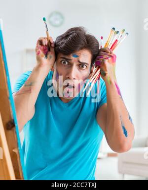 La jeune artiste drôle de travailler sur de nouveaux dans son atelier de peinture Banque D'Images