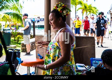 Moreea, Polynésie française: 09/03/2018: Portrait d'une femme locale habillant une robe typique avec des fleurs et des couleurs. Banque D'Images