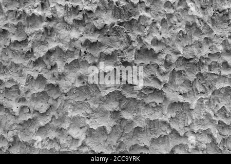 La surface du mur de ciment le rend rugueux. C'est une texture inhabituelle et vient en noir et blanc. Banque D'Images