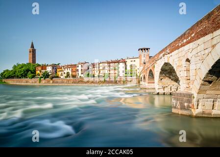 Le pont romain Ponte Pietra en pierre au-dessus de la rivière Adige avec le panorama de la vieille ville de Vérone au soleil du matin, Vénétie, Italie Banque D'Images