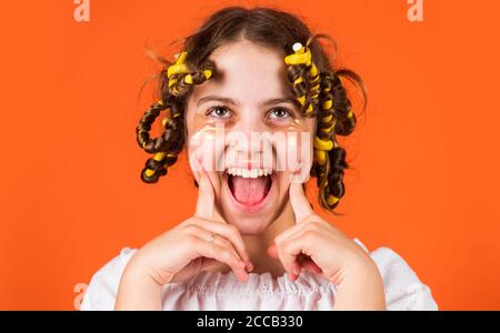 articles de coiffure et accessoires de coiffure just amuse-toi bien.. enfant avec des patches sur le visage. posez avec des pillards. happy girl dans des pillards jouant au salon de coiffure. Conseils faciles pour donner une coiffure aux enfants. Banque D'Images