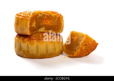 Traduction du chinois sur le dessus de la pâte de graines anglais-lotus avec des sections de gâteau de lune traditionnel jaune sur blanc sans logo ou marque commerciale Banque D'Images