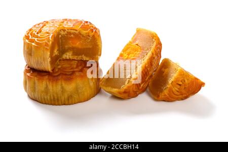 Traduction du chinois sur le dessus de la pâte de graines anglais-lotus avec des sections de gâteau de lune traditionnel jaune sur blanc sans logo ou marque commerciale Banque D'Images