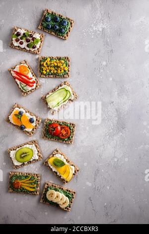 Sandwichs avec légumes, fruits, baies, chlorelle, spiruline et fromage. Bleuet, raisin, maïs, poivre, banane, mandarine, tomate, kiwi, cumbe Banque D'Images