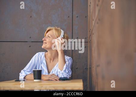 Bonne femme à l'écoute de sa musique préférée Banque D'Images