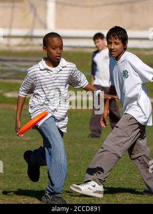 Austin, Texas États-Unis, 25 avril 2007: Les élèves de premier cycle jouent 'Ultimate Frisbee' après l'école, un jeu sans contact qui combine des éléments de football drapeau et de soccer tout en lançant un disque volant de Frisbee. ©Bob Daemmrich Banque D'Images