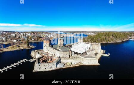 Belle vue aérienne d'Olavinlinna, ancienne forteresse d'Olofsborg, le château médiéval de trois tours du XVe siècle situé dans la ville de Savonlinna sur un soleil Banque D'Images