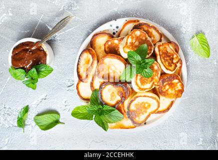 Mini crêpes sur plaque, vue de dessus de la table scène sur un fond gris. Banque D'Images