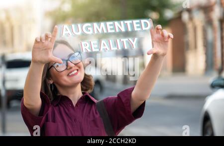 Une femme dans la rue se jette les mains. Texte réalité augmentée Banque D'Images