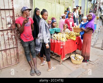 Antananarivo, Madagascar - 24 avril 2019: Groupe de malgaches inconnus debout près d'une femme qui vend des bananes dans la rue. Le pays est pauvre et n'a pas de place Banque D'Images