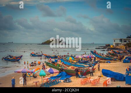 Vung Tau, Vietnam - 22 août 2020: Vue des pêcheurs locaux poussant les bateaux en bois bleu traditionnels de la mer à la côte de façon traditionnelle, ils collectent les poissons Banque D'Images