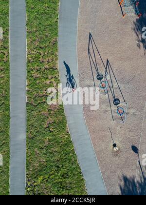 Russie, Tikhvin, Homme à vélo sur la piste près du parc de jeux, vue aérienne Banque D'Images