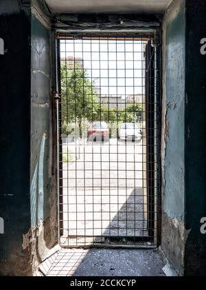 Une grille de fer à la sortie de la prison et de la forteresse enfermée dans un couloir avec de vieux murs. Violation de la loi et protection fiable. Banque D'Images