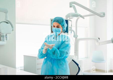 Une infirmière porte des gants dans le cabinet du dentiste Banque D'Images