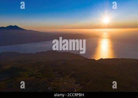 Coucher de soleil avec brume au sommet du parc national de Vicente Perez Rosales avec vue sur la forêt indigène, le lac de llanquihue et le volcan Calbuco Banque D'Images