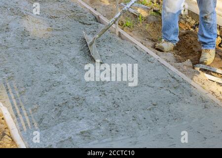 Poser un nouveau trottoir dans du béton humide sur des trottoirs fraîchement coulées Banque D'Images