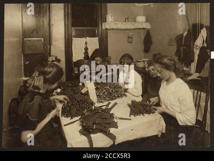 Famille juive travaillant sur les jarretières dans la cuisine pour le logement de principe. (Pour plus de détails, voir Mlle E.C. Rapport de Watson.) Banque D'Images