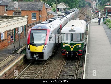 Chappel et réveille la gare de Colne avec une nouvelle grande Anglia Train bi-mode de classe 755/3 le long du musée du chemin de fer East Anglian bus ferroviaire des années 1950 Banque D'Images