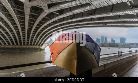 Se réfugiant sous la pluie sous le pont Blackfriars à Londres. Banque D'Images