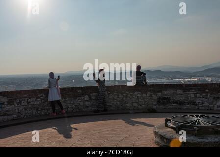 Egyptiennes avec smartphon sur le toit-terrasse avec vue aérienne de la vieille ville italienne de Brescia. Banque D'Images