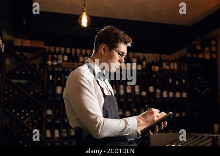 Le sommelier de l'hôtel s'assortira au choix du vin du client Son goût vintage et de donner des échantillons de différentes spécialités dans restaurant Banque D'Images