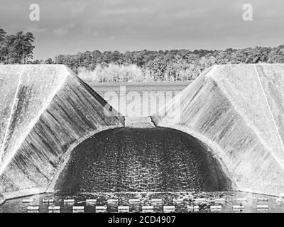 The Woodlands TX USA - 02-03-2020 - Concrete Dam Outlet Avec débit d'eau en noir et blanc Banque D'Images