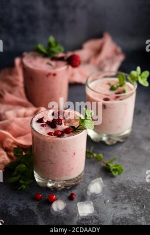 Verres de smoothie aux baies sur fond sombre. Banque D'Images