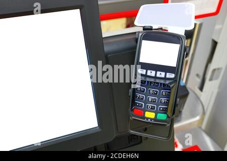 Lecteur de carte de crédit ou borne de pos avec espace de copie sur l'écran dans un supermarché. Sur la gauche, un écran de moniteur avec espace de copie est affiché. Le concept Banque D'Images