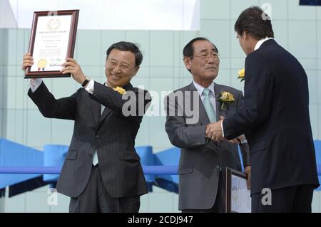 DOSSIER Austin, TX 14 juin 2007 : le Dr Chang-Gyu Huang (l) et le PDG Jong-Yong Yun (c) reçoivent un prix « Texan honoraire » décerné par le gouverneur du Texas Rick Perry (r) lors des cérémonies d'ouverture à Samsung Austin Semiconductor (SAS) pour l'usine de fabrication « Fab 2 », qui présente l'investissement américain de plusieurs milliards de dollars du fabricant coréen de puces. ©Bob Daemmrich Banque D'Images