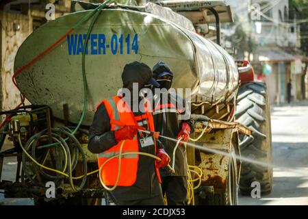 Gaza, Palestine. 28 août 2020. Les travailleurs palestiniens vaporisent du désinfectant sur les routes et les bâtiments de la ville de Gaza vendredi (28 août) alors que le coronavirus se poursuit. (Photo de Ramez Habboub/Pacific Press) crédit: Pacific Press Media production Corp./Alay Live News Banque D'Images