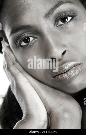 Modèle féminin sombre reposant sur les mains Banque D'Images