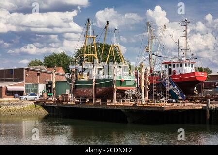 Quai sec d'un chantier naval dans le port de pêche pendant travaux de réparation sur les bateaux à crevettes Banque D'Images