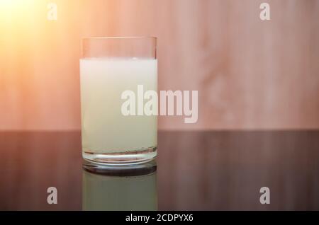 le comprimé effervescent se dissout dans un verre d'eau sur un table noire Banque D'Images