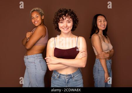 Jeune belle brune femme debout devant deux autres femmes Banque D'Images