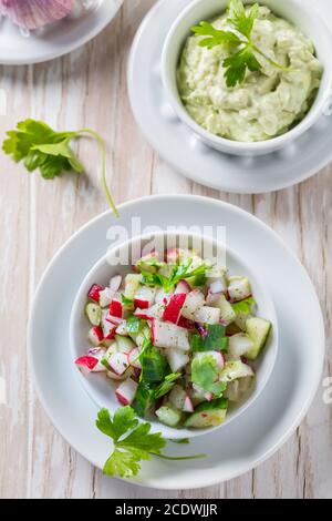 Salade de radis au concombre et à l'oignon avec une délicieuse sauce à l'avocat. Concept d'alimentation saine. Banque D'Images