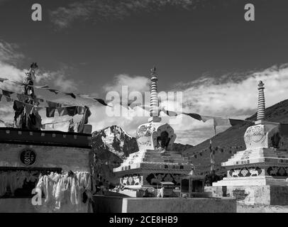 Stupas bouddhiste avec drapeaux de prière surplombant l'Himalaya à pic de neige sous le ciel bleu entre Manali et Kaza, Himachal Pradesh, Inde. Banque D'Images