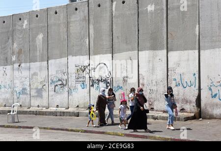 Camp de réfugiés de Shurafat, Israël. 31 août 2020. Les Palestiniens marchent à côté du mur de séparation israélien dans le camp de réfugiés de Shurafat, près de Jérusalem, le lundi 31 août 2020. Le conseiller présidentiel américain Jared Kushner a appelé les Palestiniens à reprendre les négociations avec Israël et à ne pas être « dans le passé » à leur arrivée à l'AUE lors du premier vol direct entre Israël et Abu Dhabi. Photo par Debbie Hill/UPI crédit: UPI/Alay Live News Banque D'Images