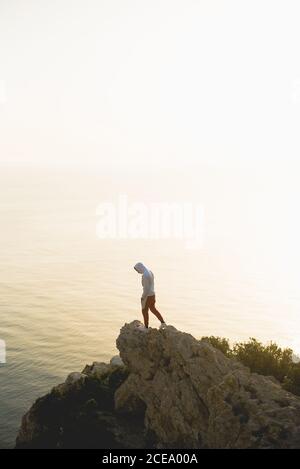 homme avec capot debout sur des rochers Banque D'Images