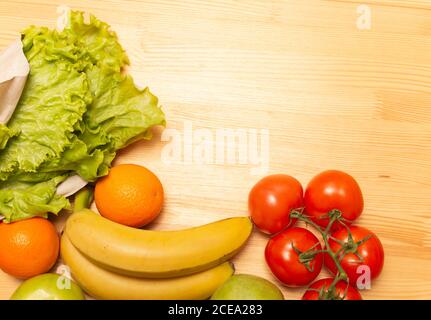 Service de livraison de nourriture. Nourriture saine sur table en bois. Acheter en ligne pendant la quarantaine. Tomates, pommes, bananes, oranges, salade. Photo de haute qualité. Séjour Banque D'Images
