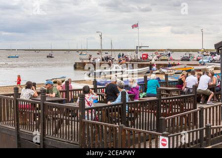 Orford Quay à Orford, Suffolk, Royaume-Uni. Clients au Riverside Tearoom en premier plan. Banque D'Images