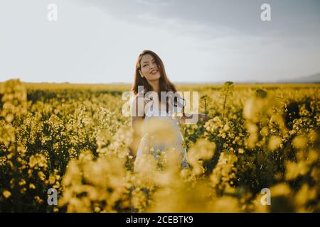 Femme avec fleurs dans le champ Banque D'Images