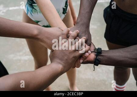 Group of friends stacking hands Stock Photo