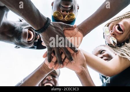 Group of friends stacking hands Stock Photo