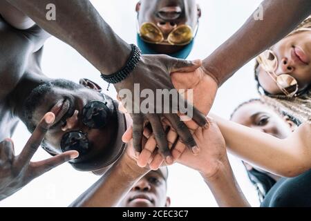 Group of friends stacking hands Stock Photo